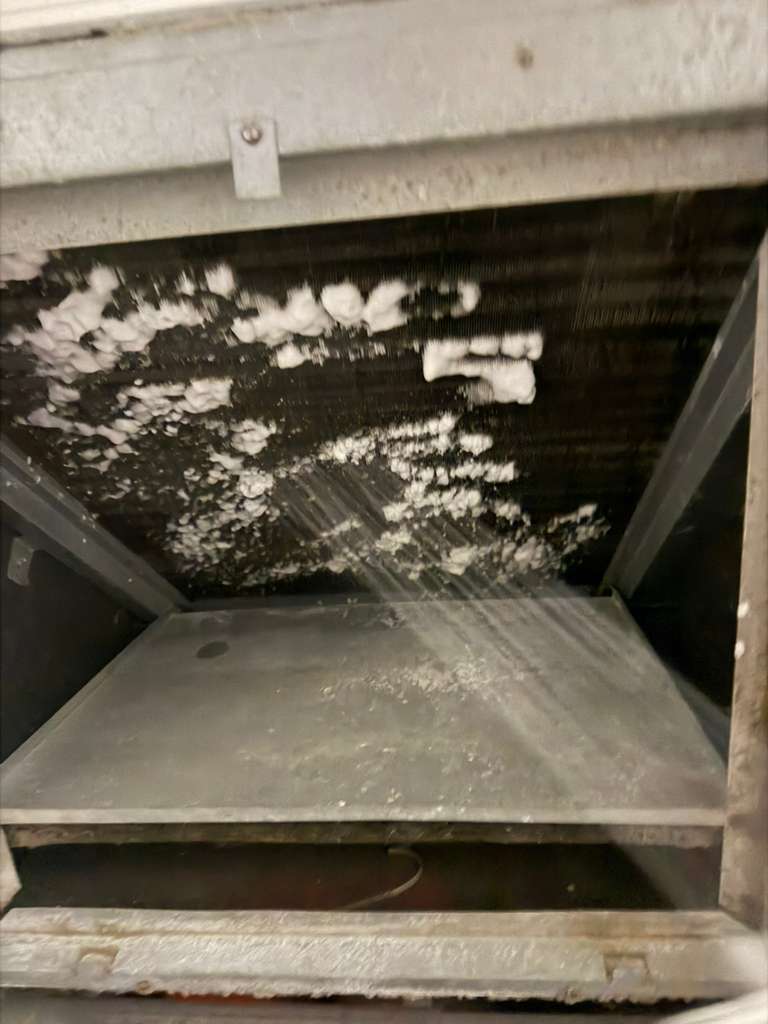 AC coil being flushed and cleaned — before and after treatment
