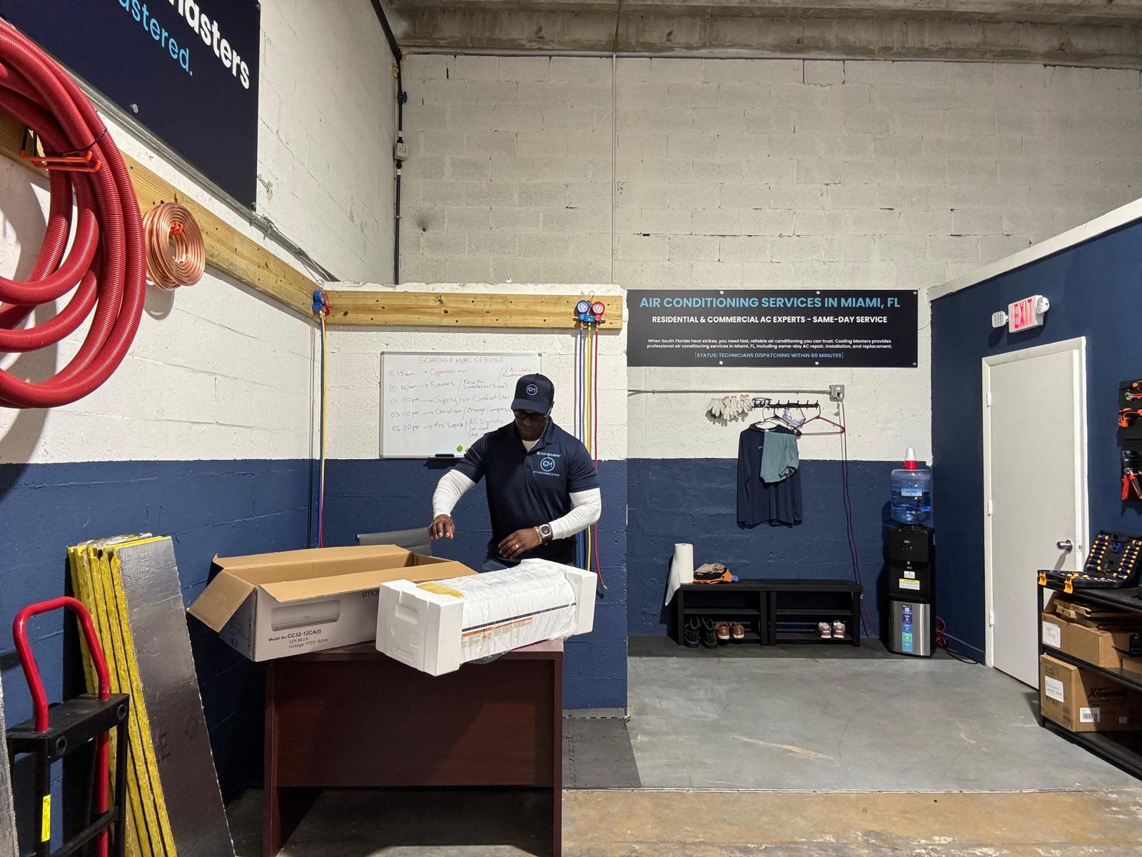 Cooling Masters team member unpacking new AC unit at Miami showroom