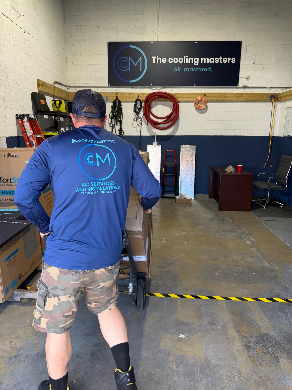 Cooling Masters technician with AC unit at Miami HVAC headquarters