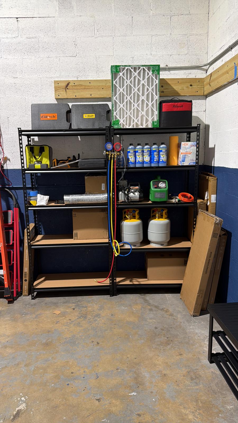 Cooling Masters HVAC tool shelves — refrigerant tanks, manifold gauges, Elitech vacuum pump, Yellow Jacket equipment, air filters